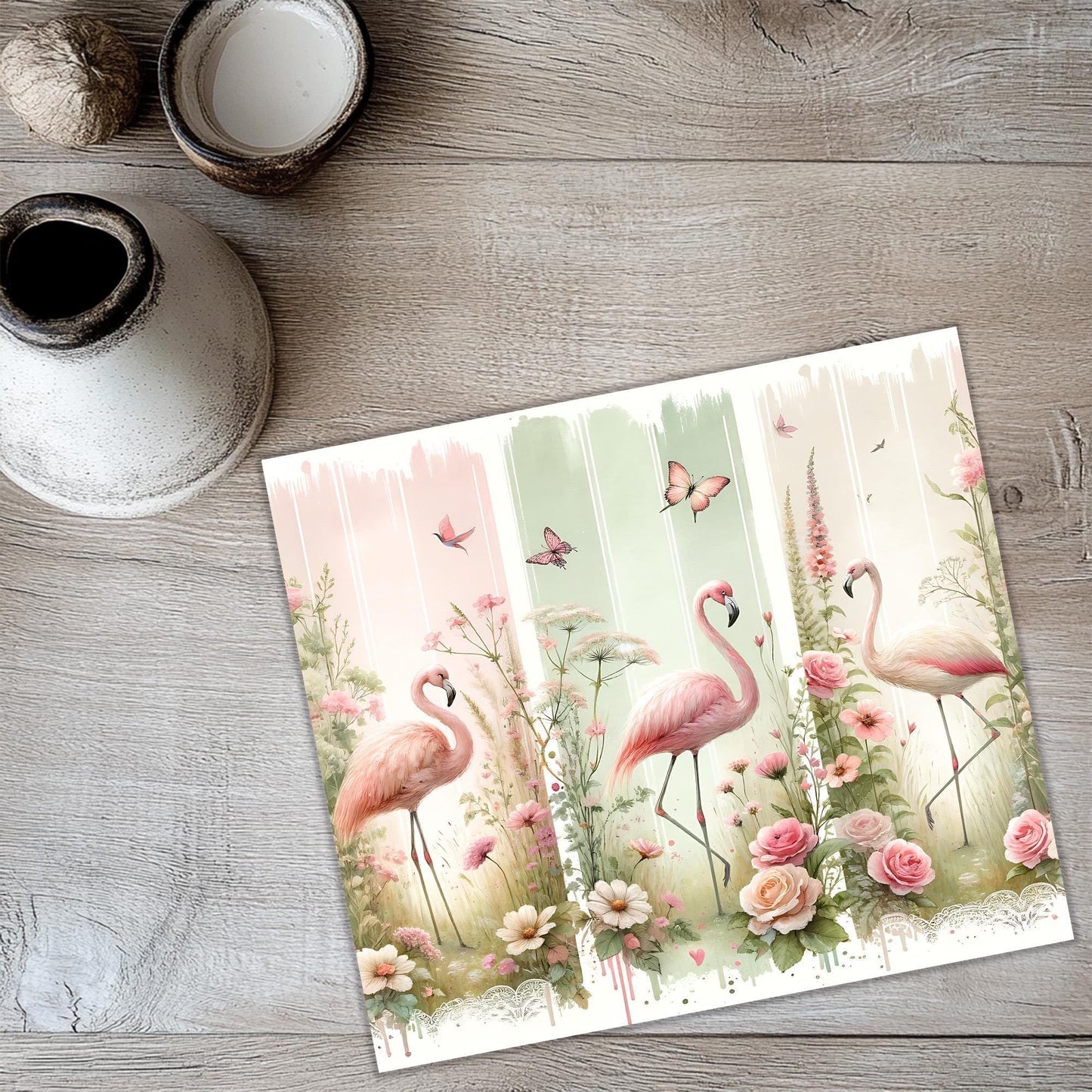 a card with three flamingos in a field of flowers