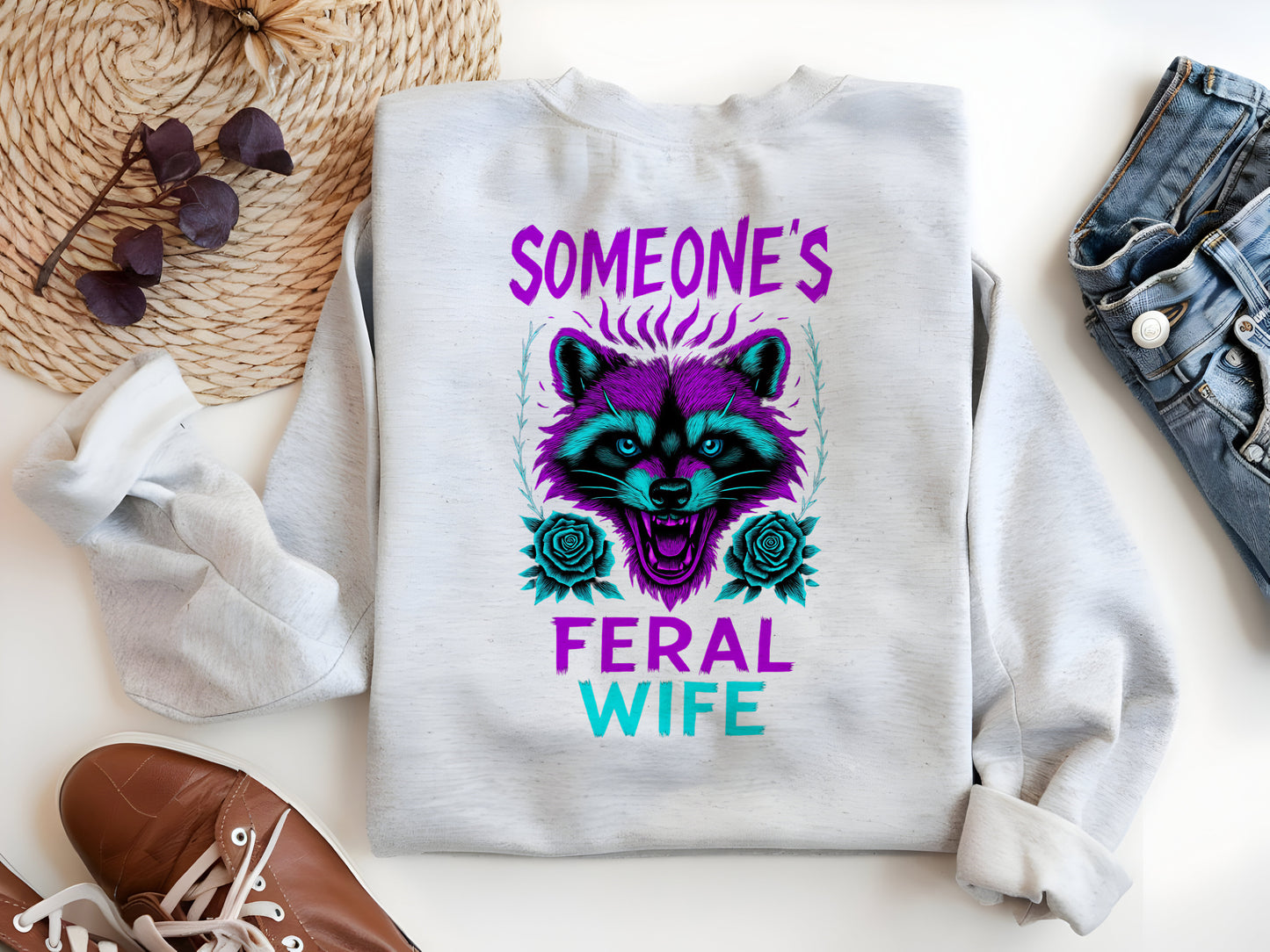 a white sweatshirt with a raccoon on it