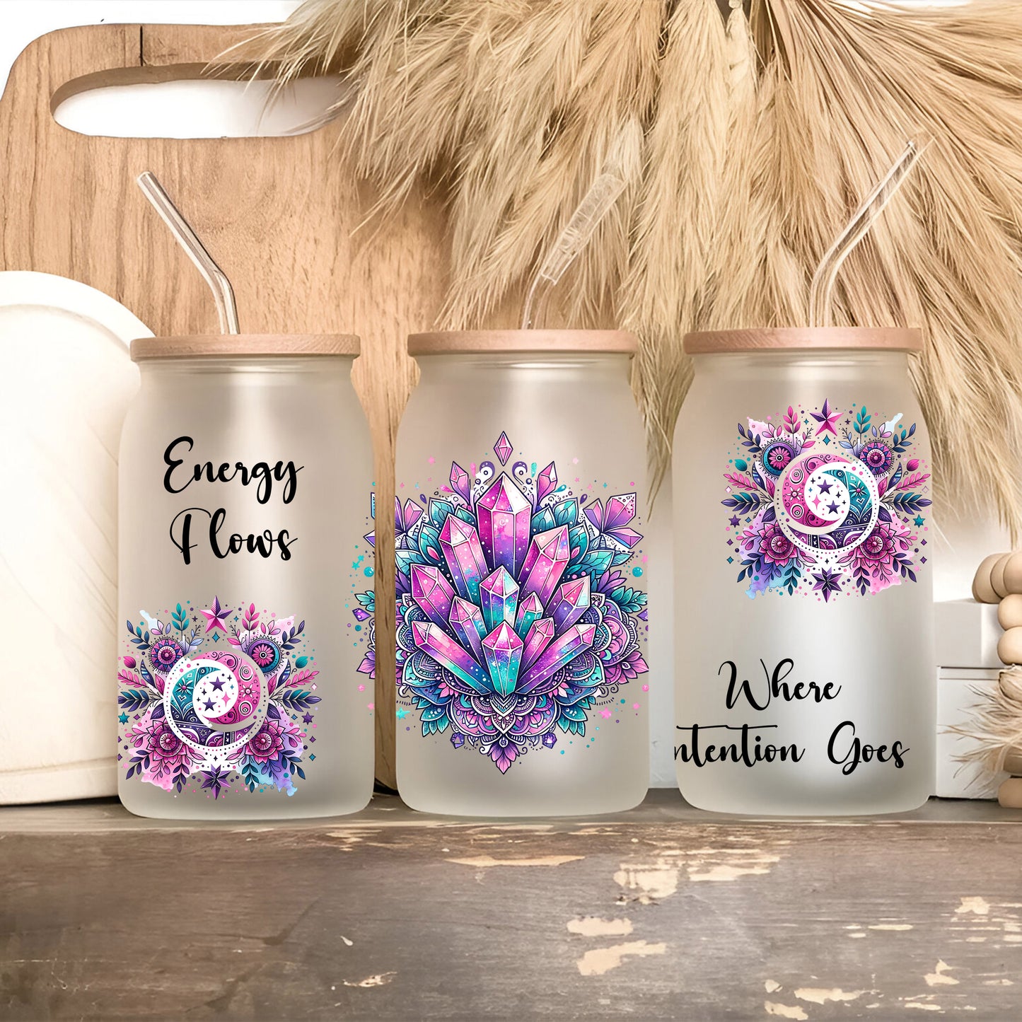 three canisters with designs on them sitting on a shelf