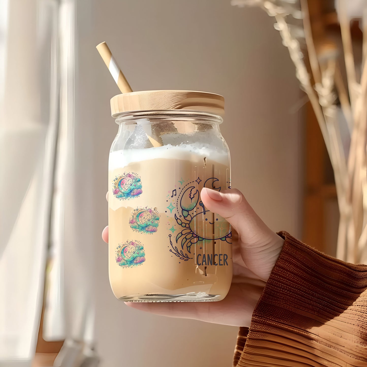 a person holding a jar with a straw in it