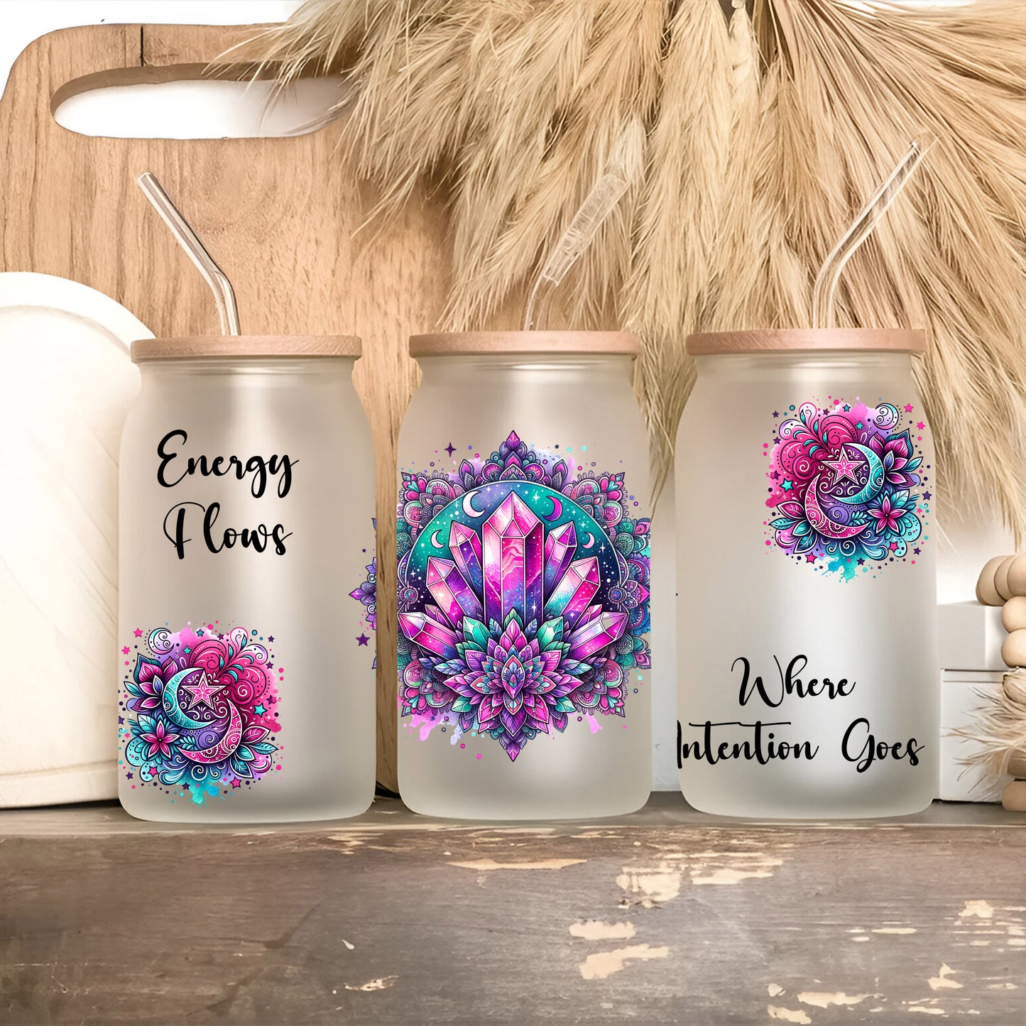 three canisters with designs on them sitting on a shelf
