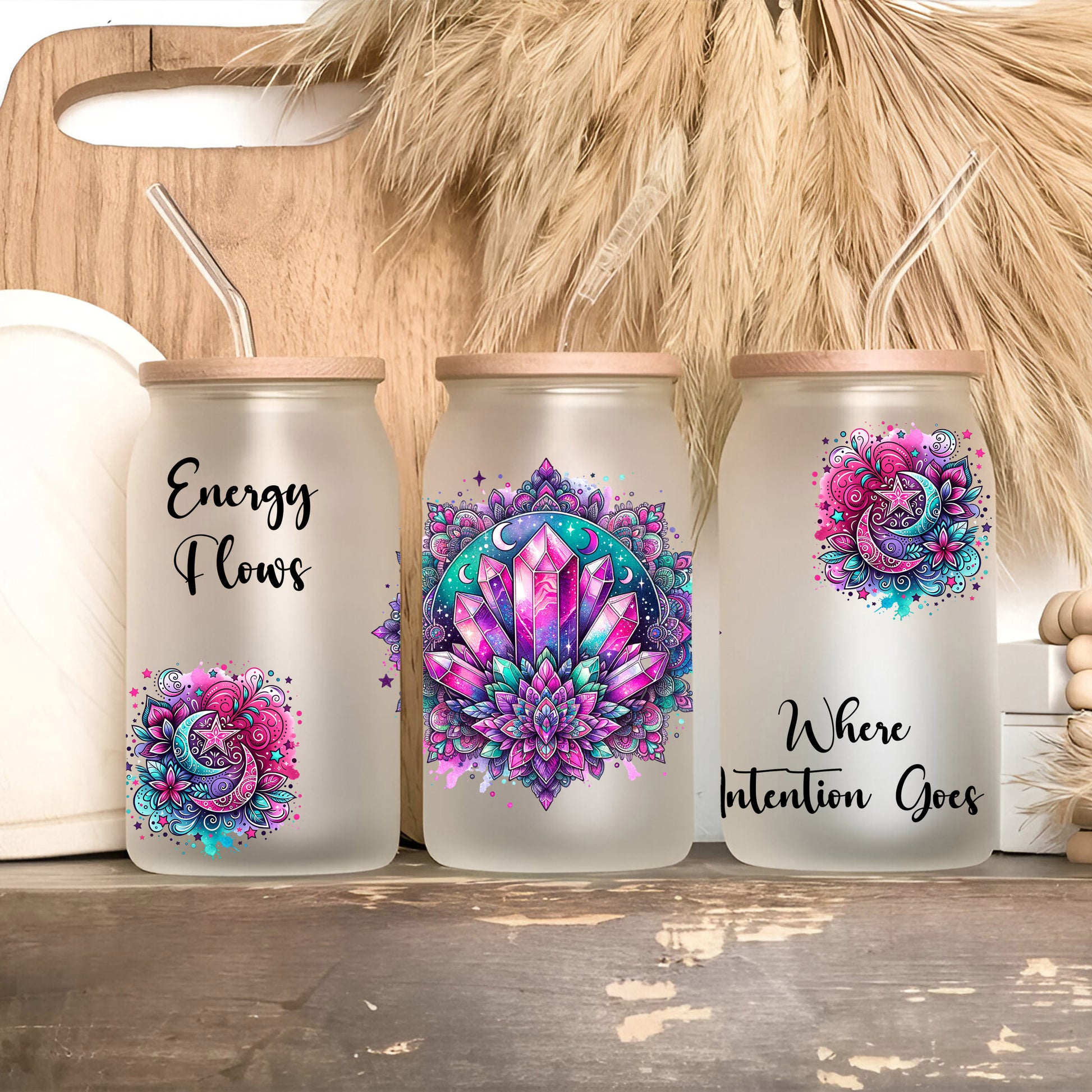 three canisters with designs on them sitting on a shelf