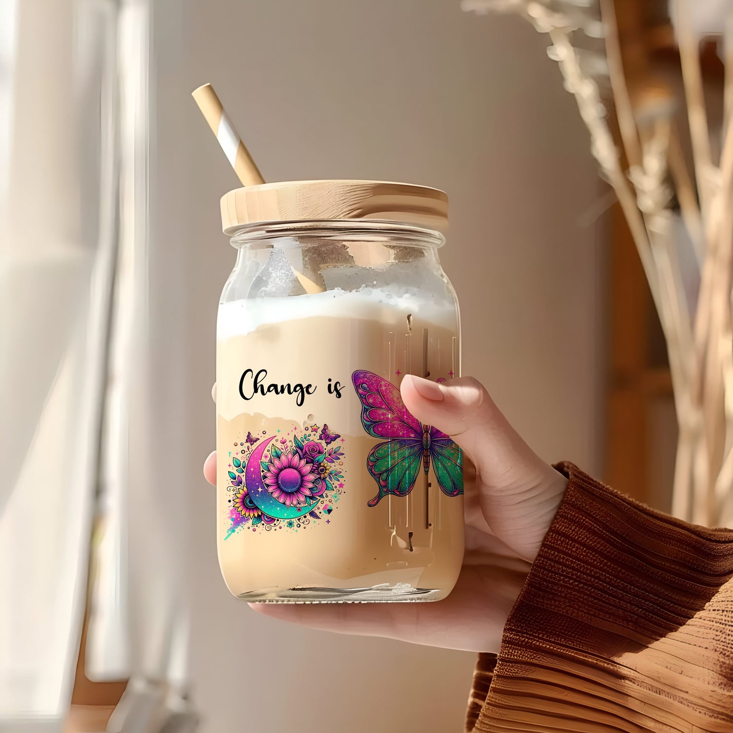 a person holding a jar with a straw in it