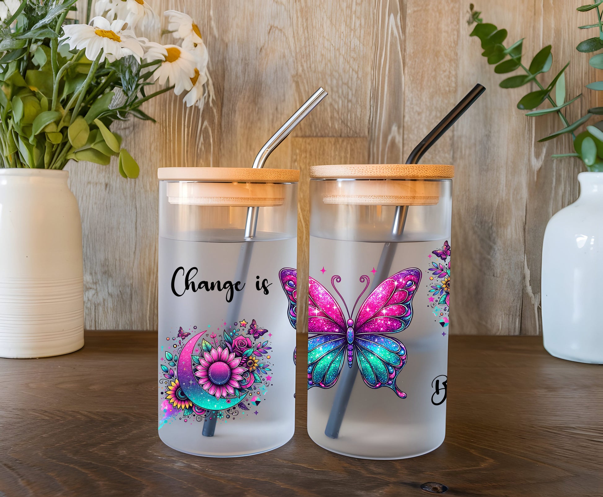 a couple of glass cups sitting on top of a wooden table