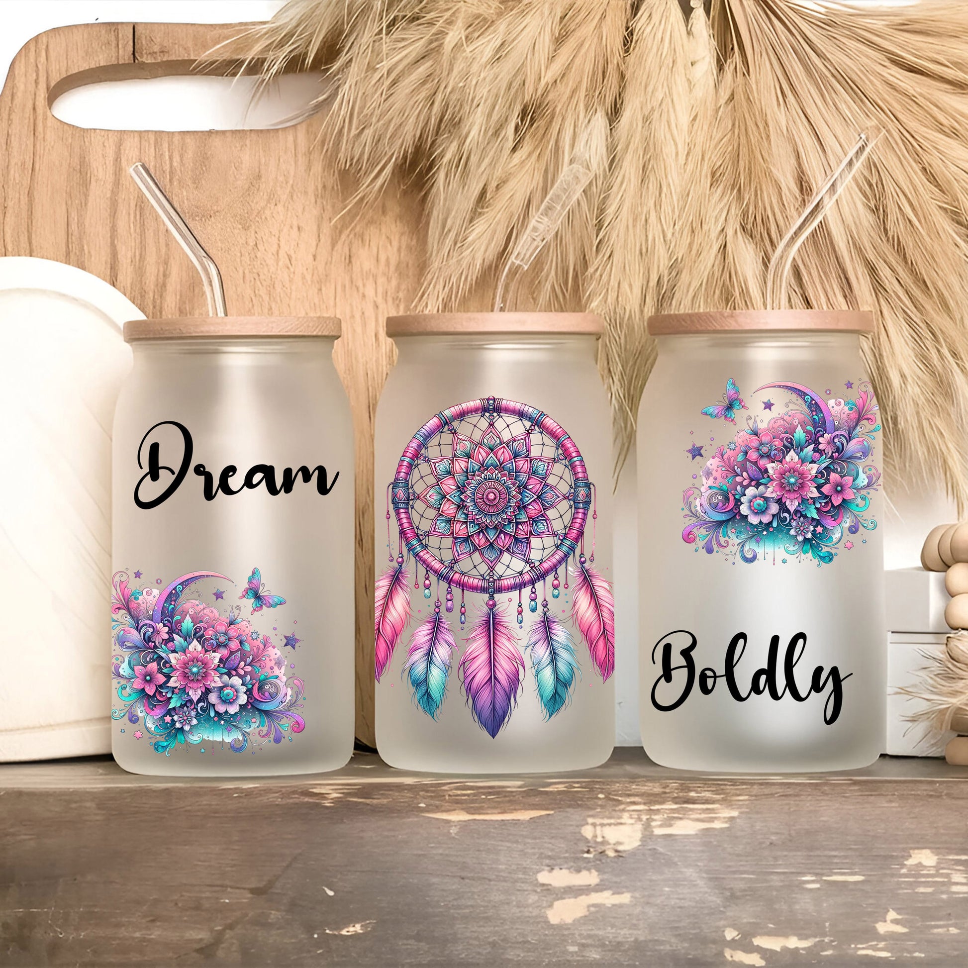 three mason jars with dream catchers painted on them