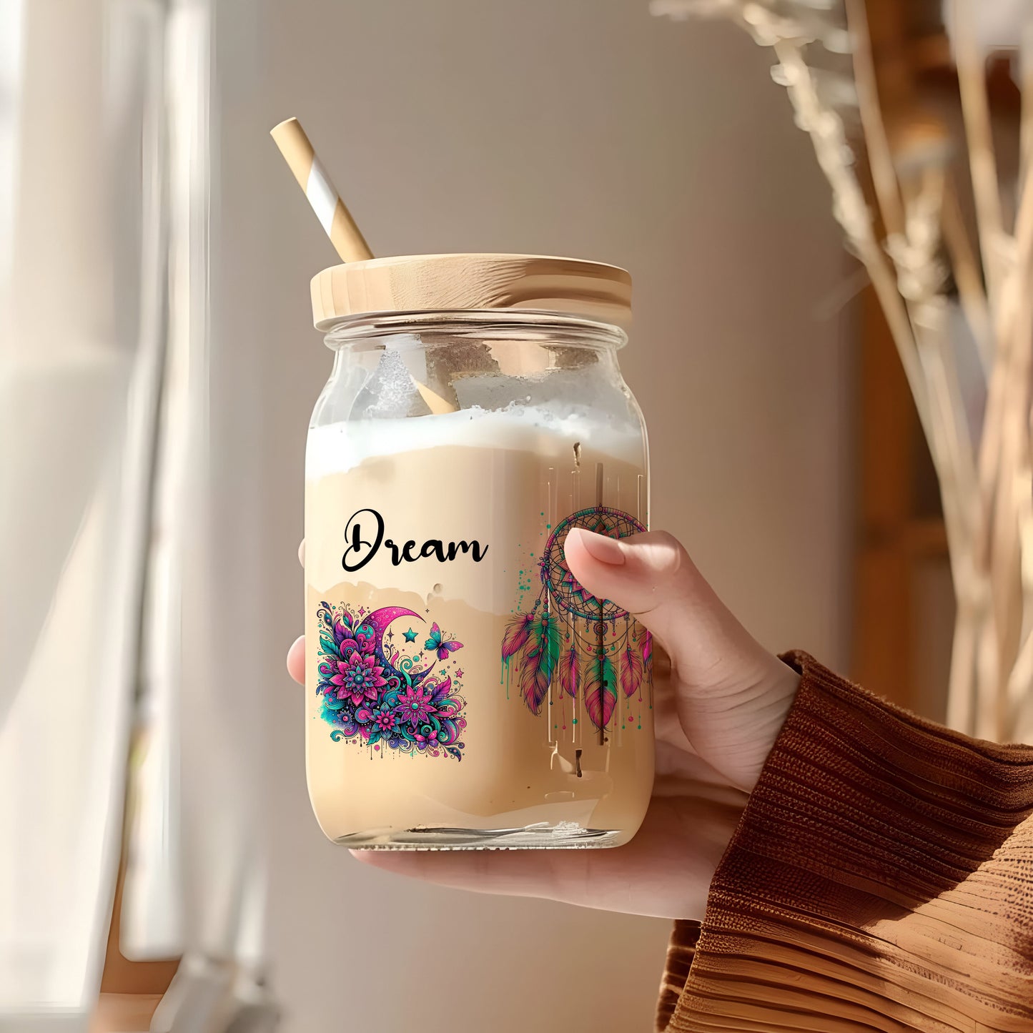 a person holding a jar with a straw in it