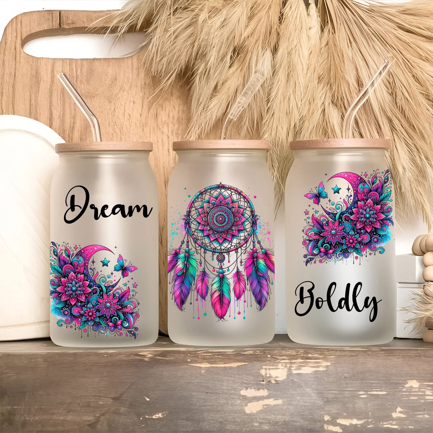 three mason jars with dream catchers painted on them