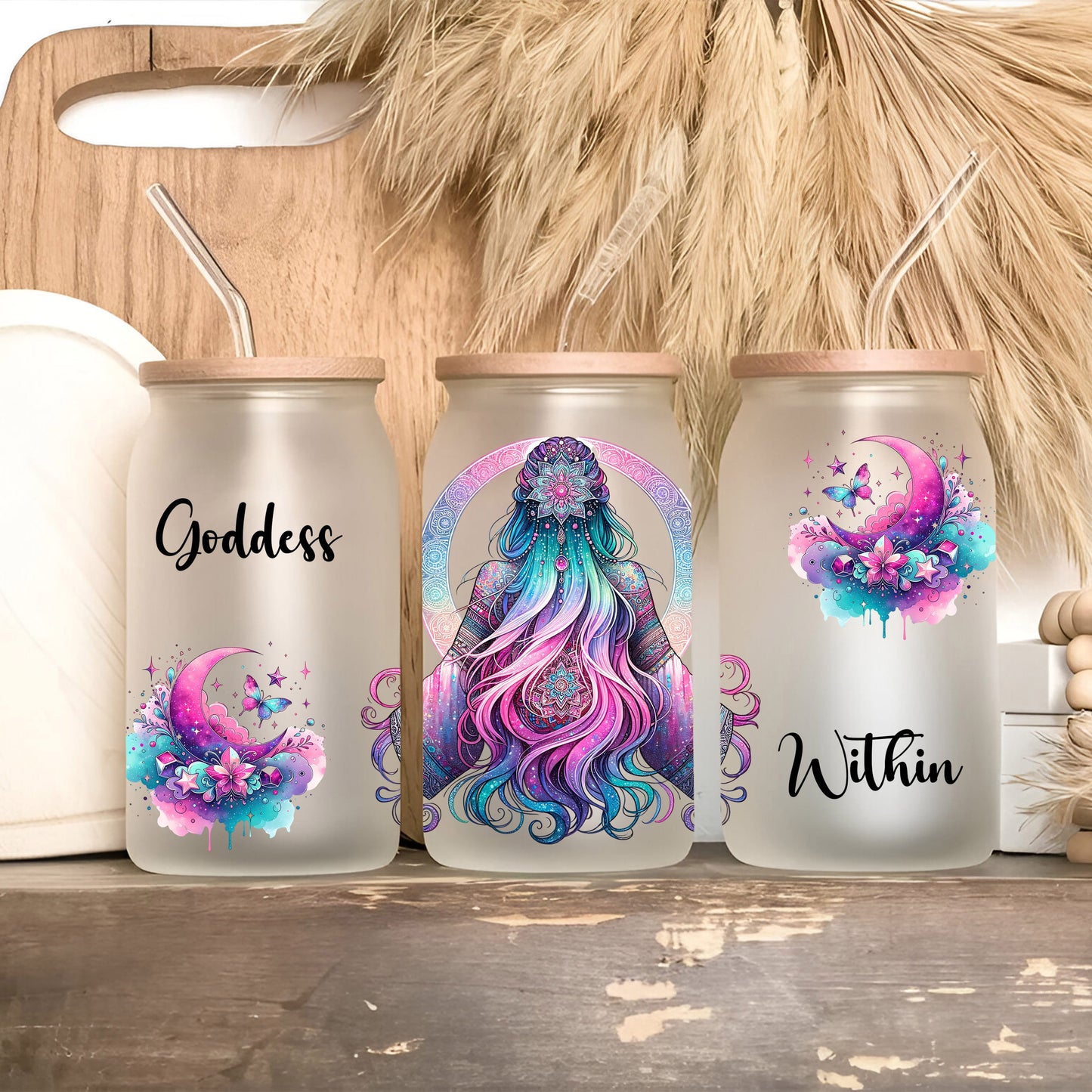 three white canisters with designs on them