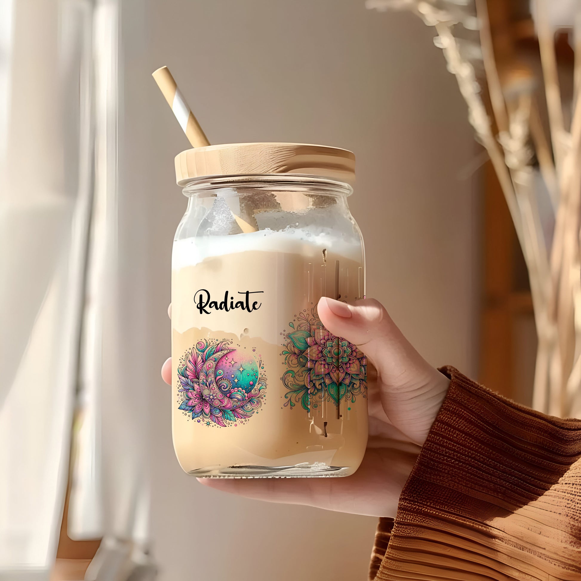 a person holding a jar with a straw in it