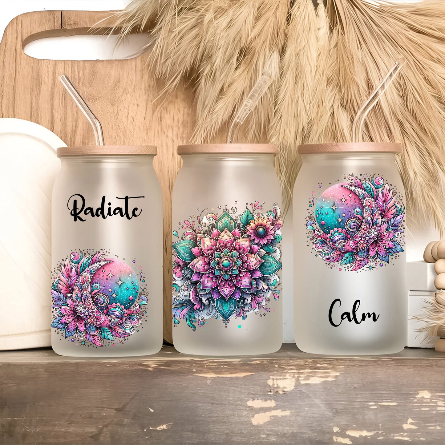 three painted mason jars sitting on a shelf