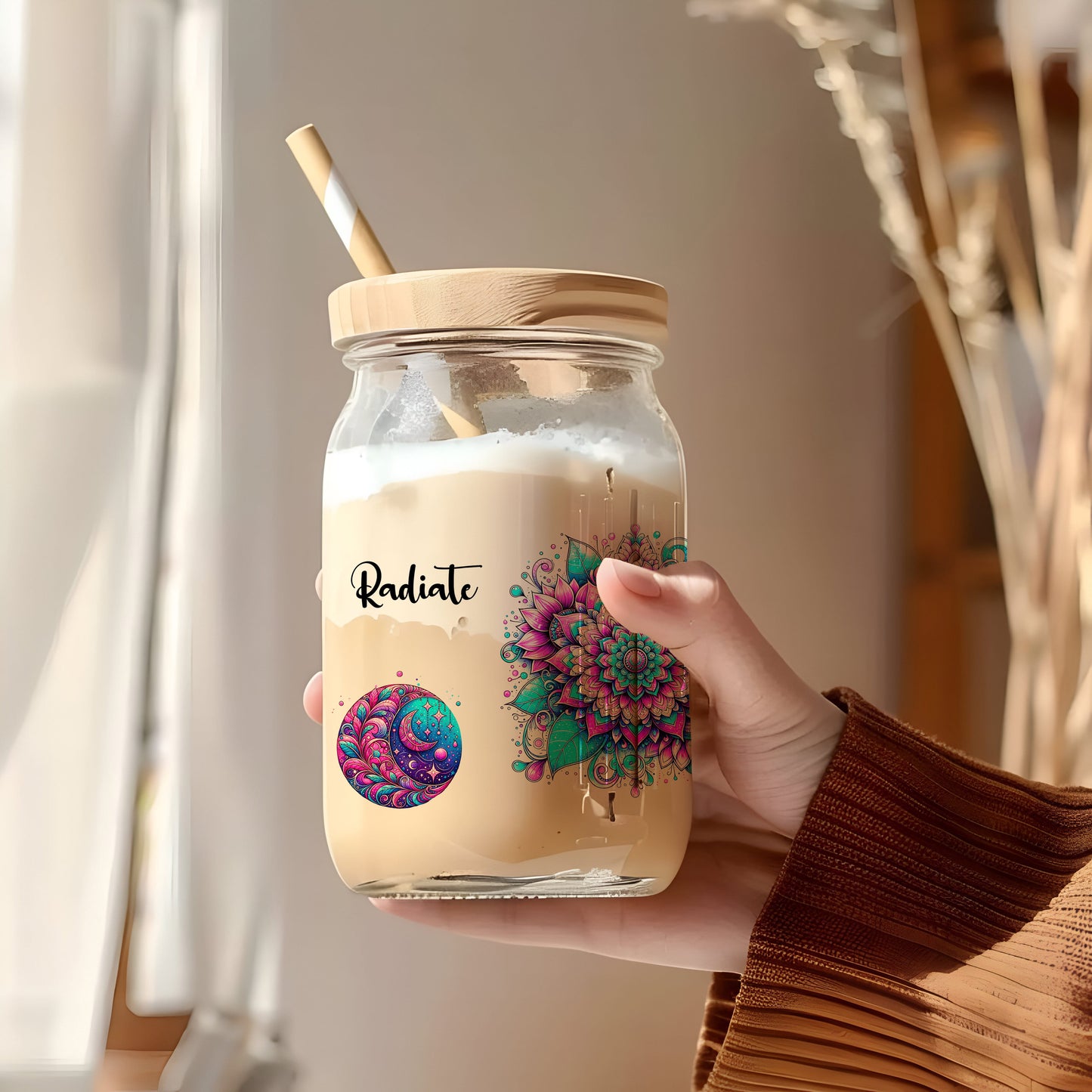 a person holding a jar with a straw in it