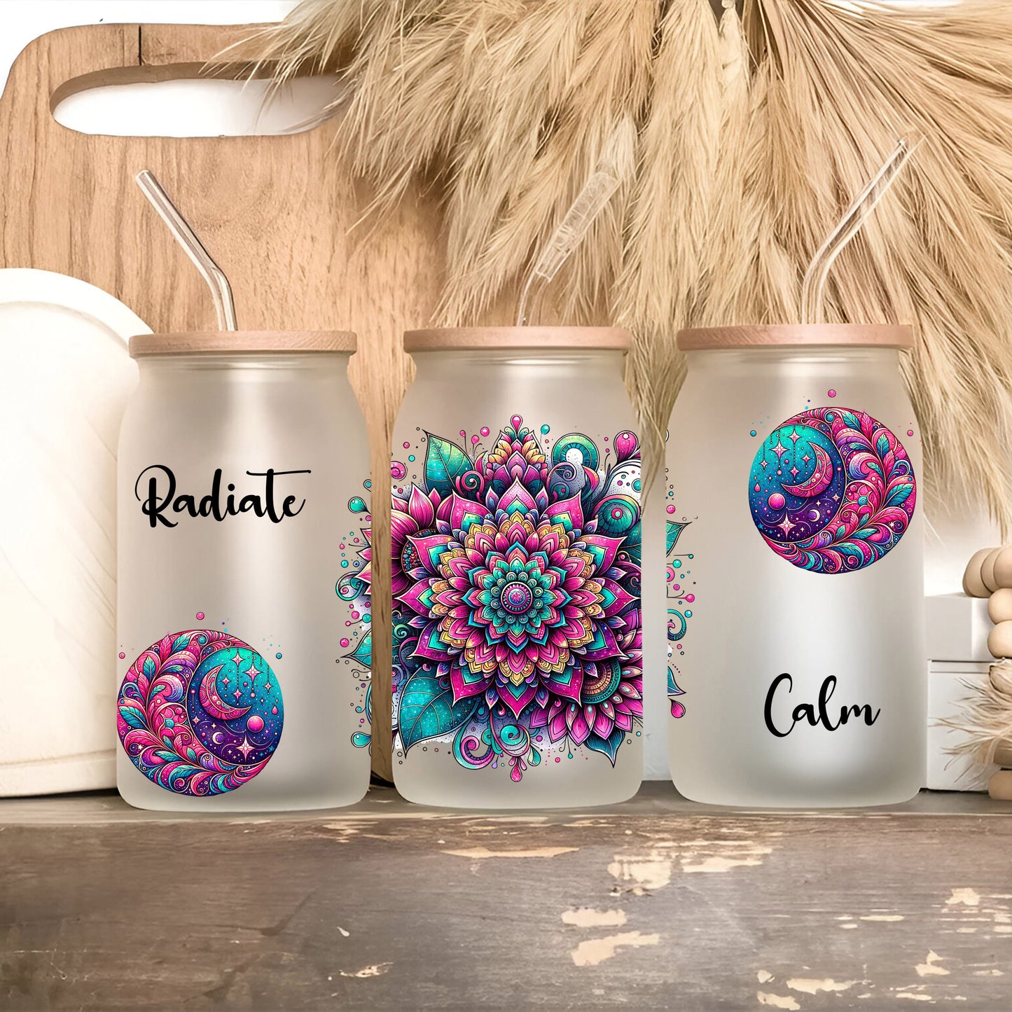 three canisters with designs on them sitting on a shelf