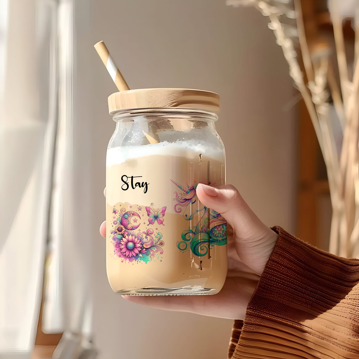 a person holding a jar with a straw in it