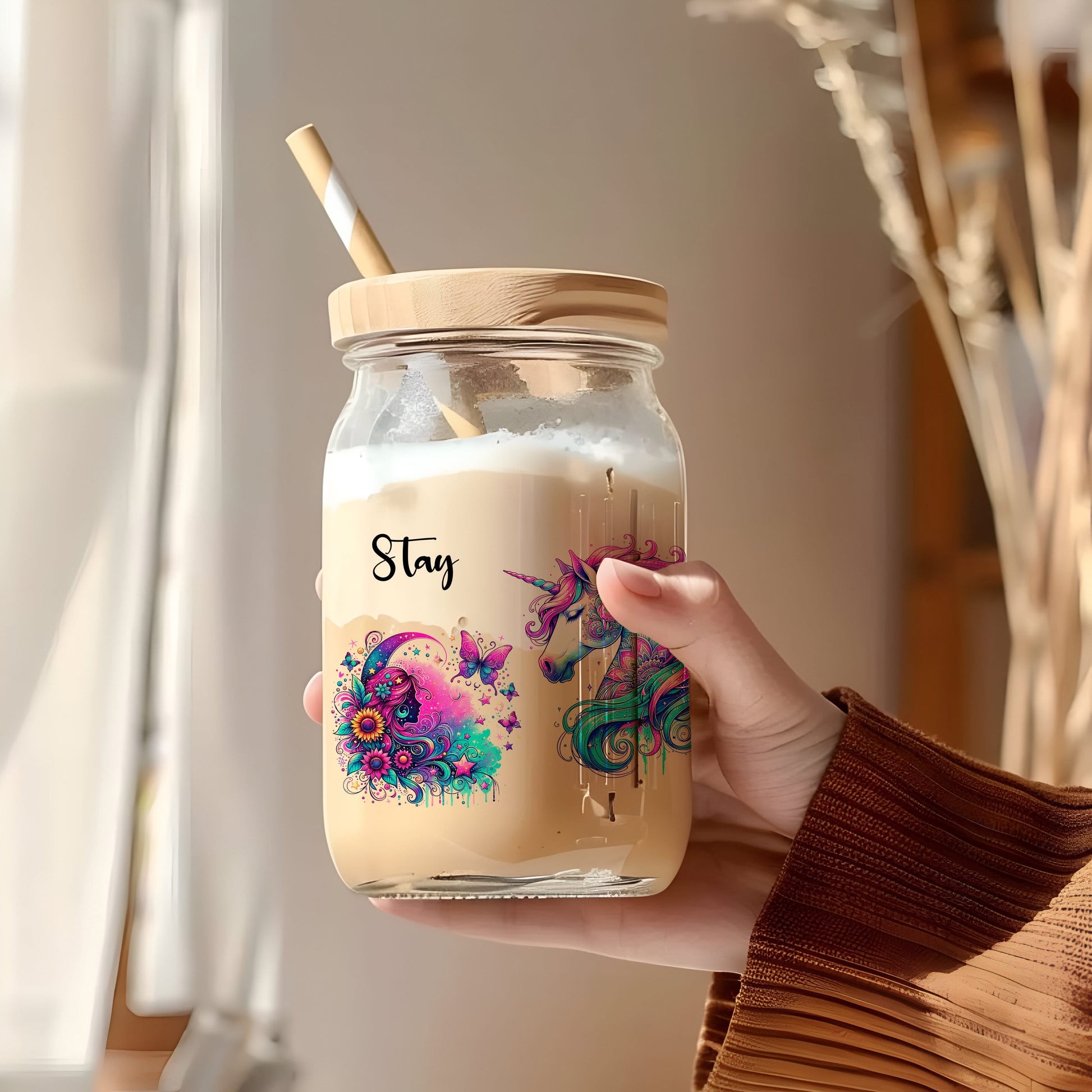 a person holding a jar with a straw in it