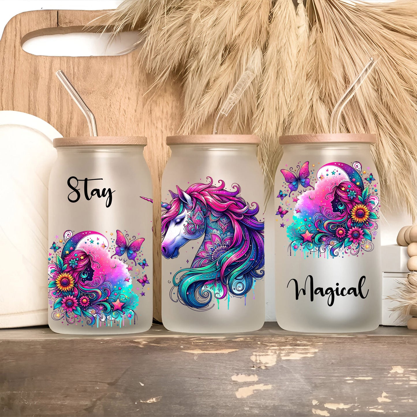 three personalized tumblers with unicorns painted on them