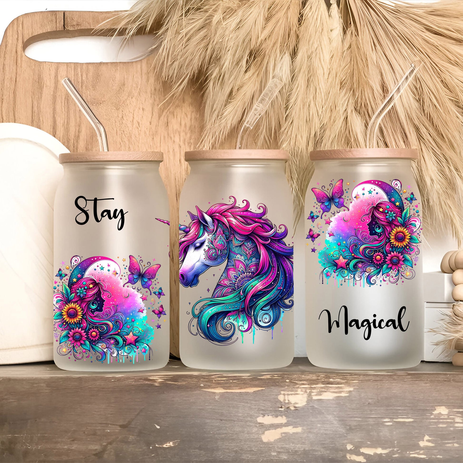 three personalized tumblers with unicorns painted on them