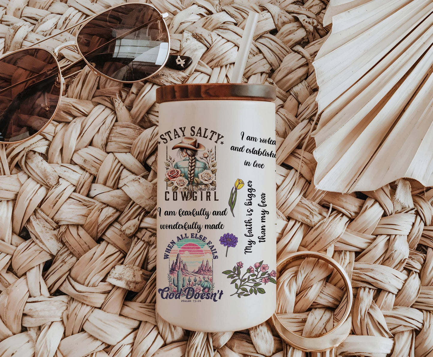 a coffee cup with a straw hat and sunglasses on top of it