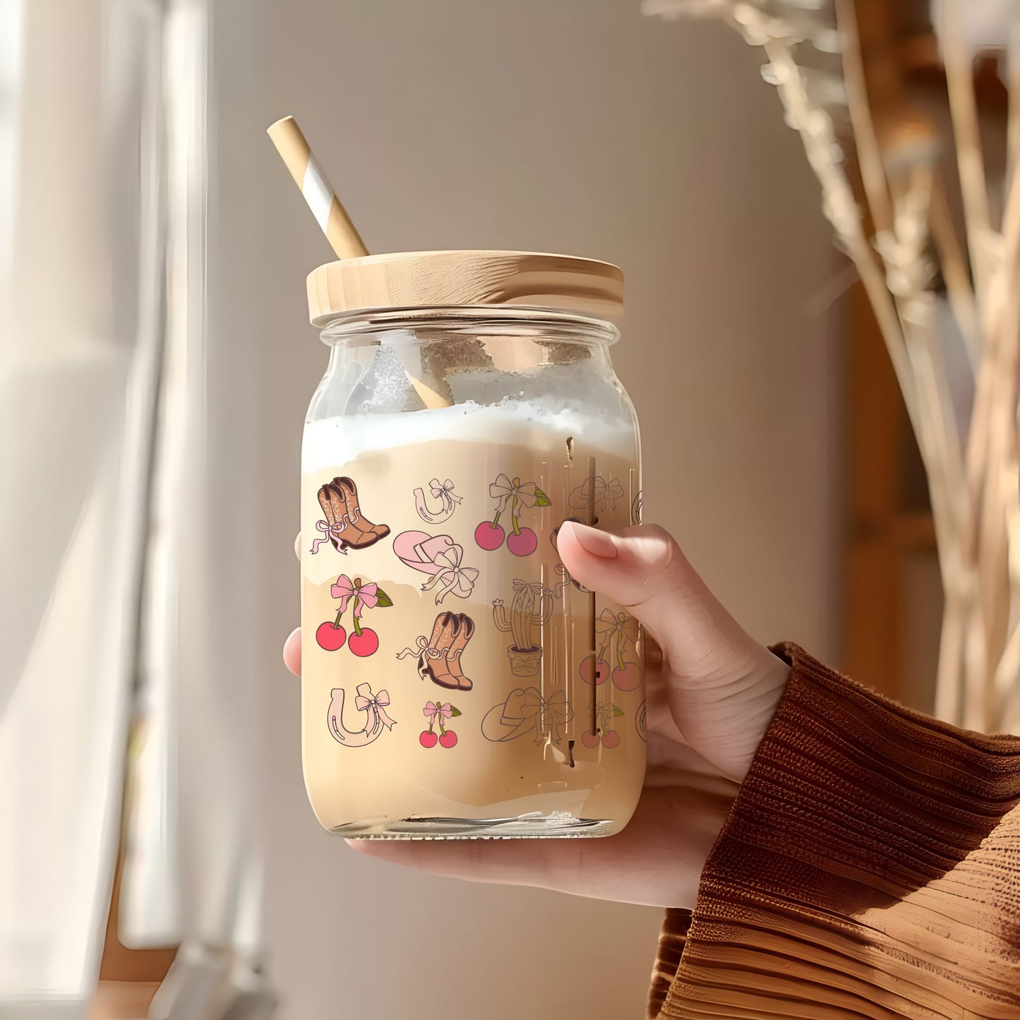 a person holding a jar with a straw in it