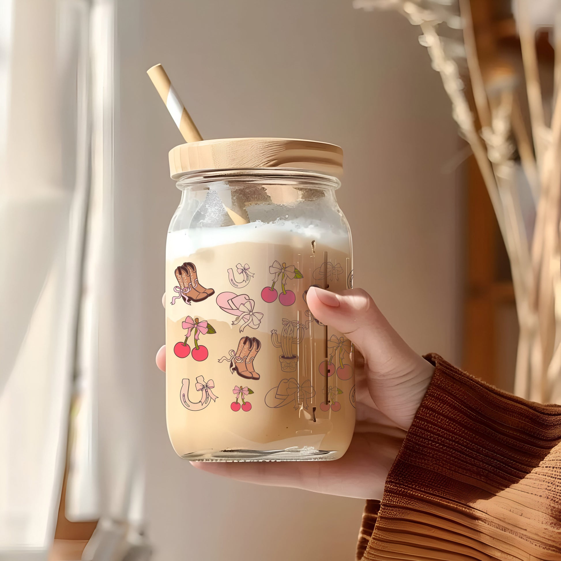 a person holding a jar with a straw in it