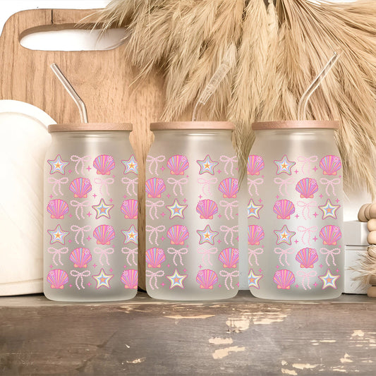 three water bottles with pink and white designs on them