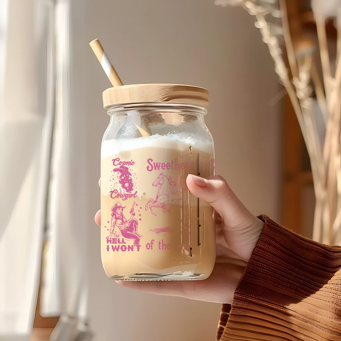 a person holding a jar with a straw in it