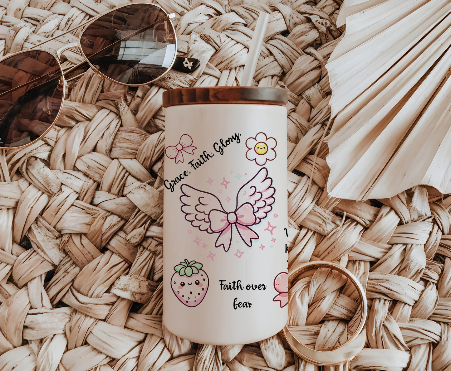 a cup with a straw hat and sunglasses on top of it