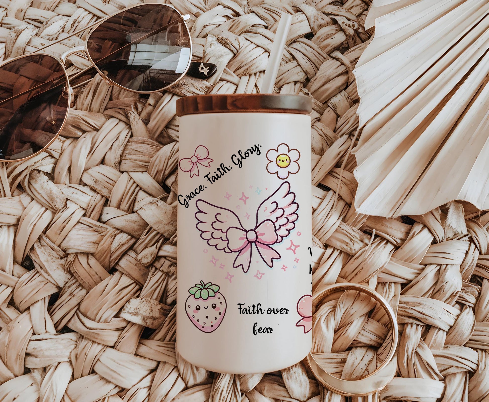 a cup with a straw hat and sunglasses on top of it