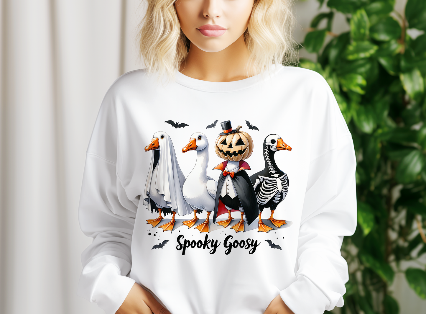 a woman wearing a white shirt with a picture of ducks and geese on it