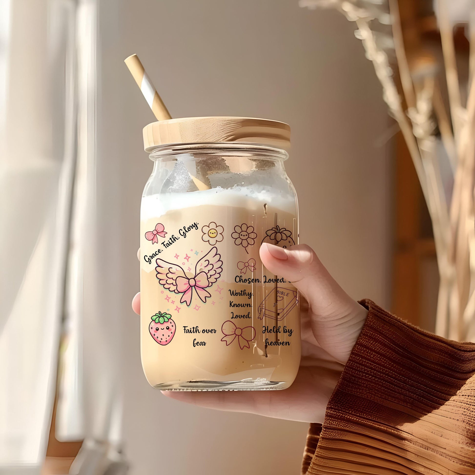 a person holding a jar with a straw in it