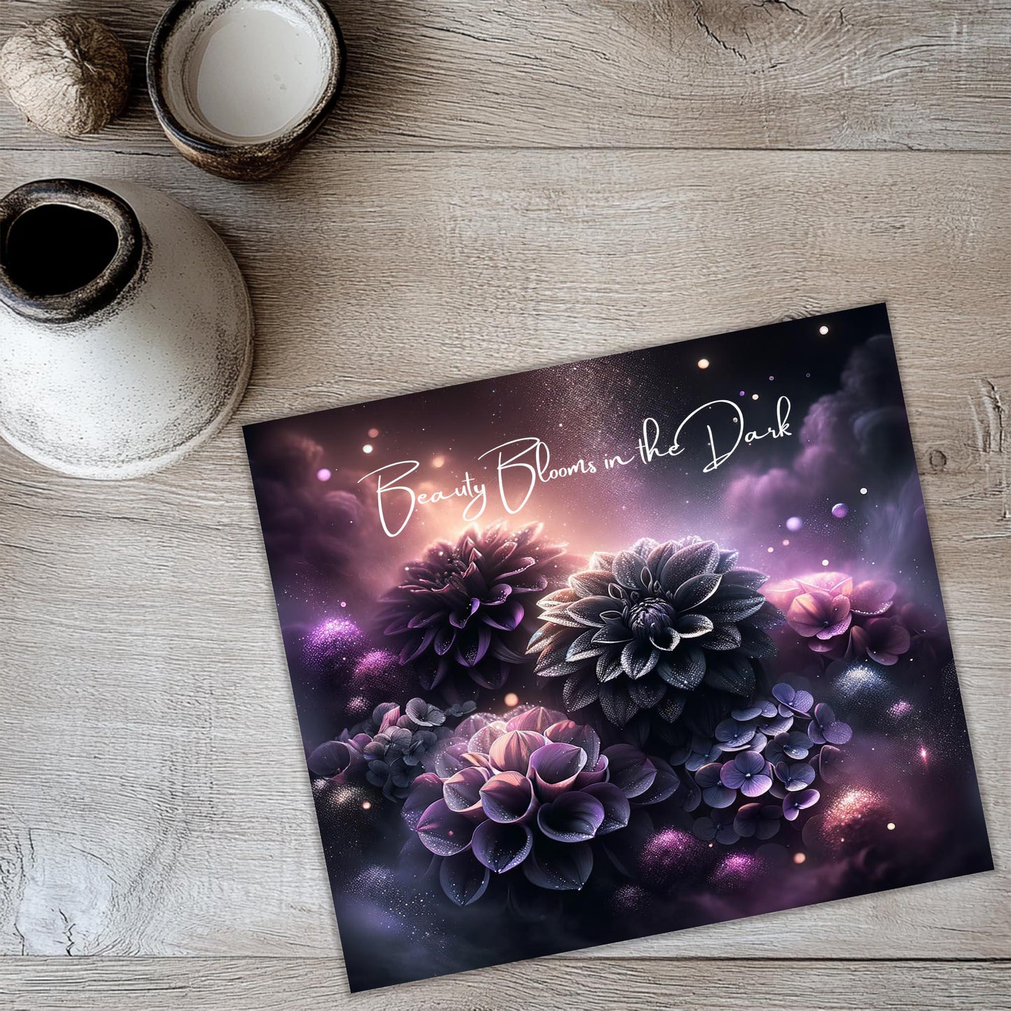 a greeting card with purple flowers on a wooden table