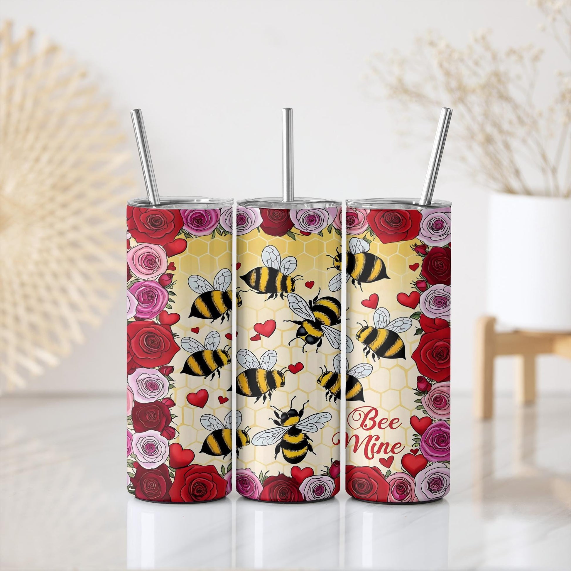 a set of three tumblers with bees and roses on them