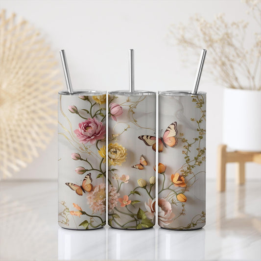 a set of three tumbles with flowers and butterflies on them