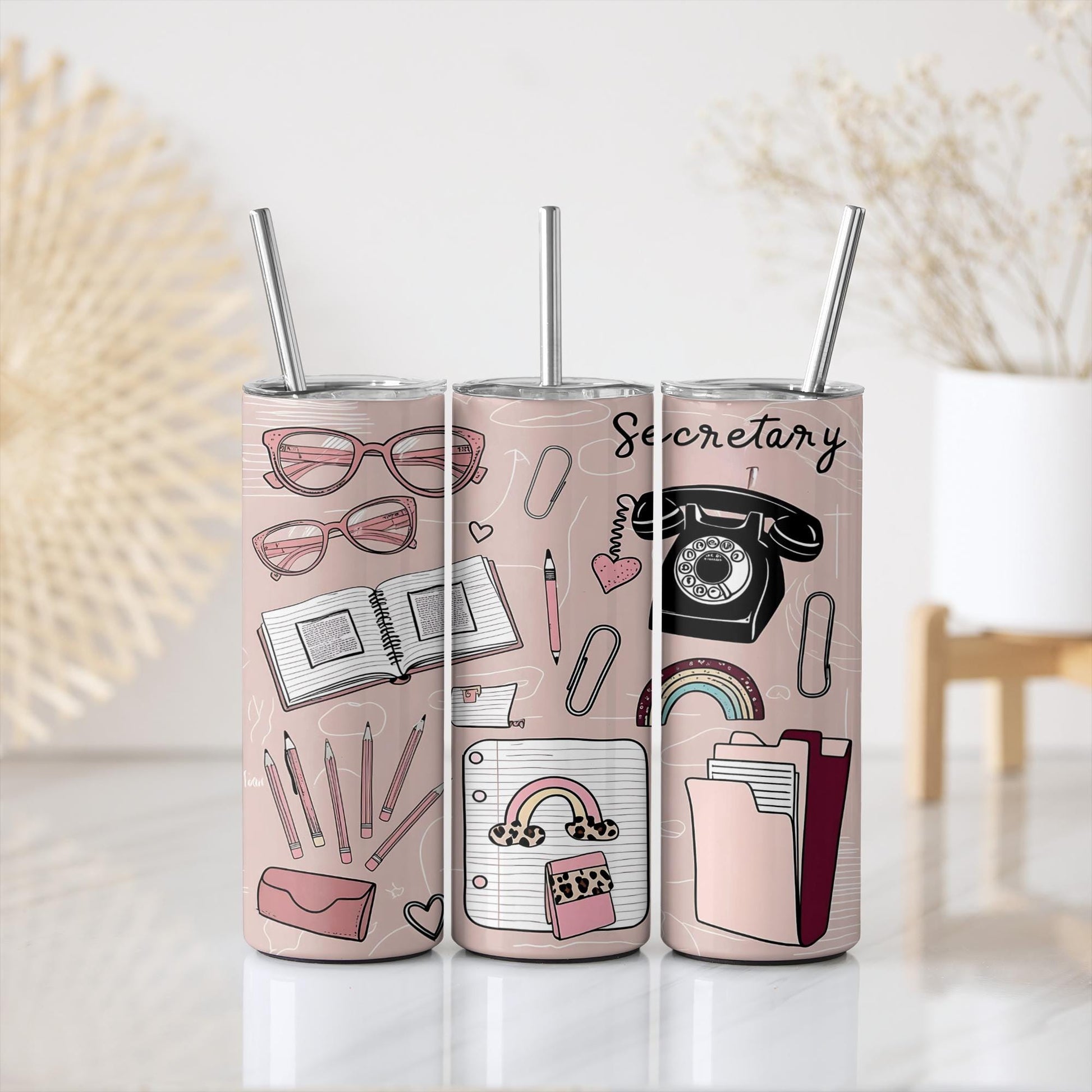 a pair of pink tumblers with a picture of different things on them