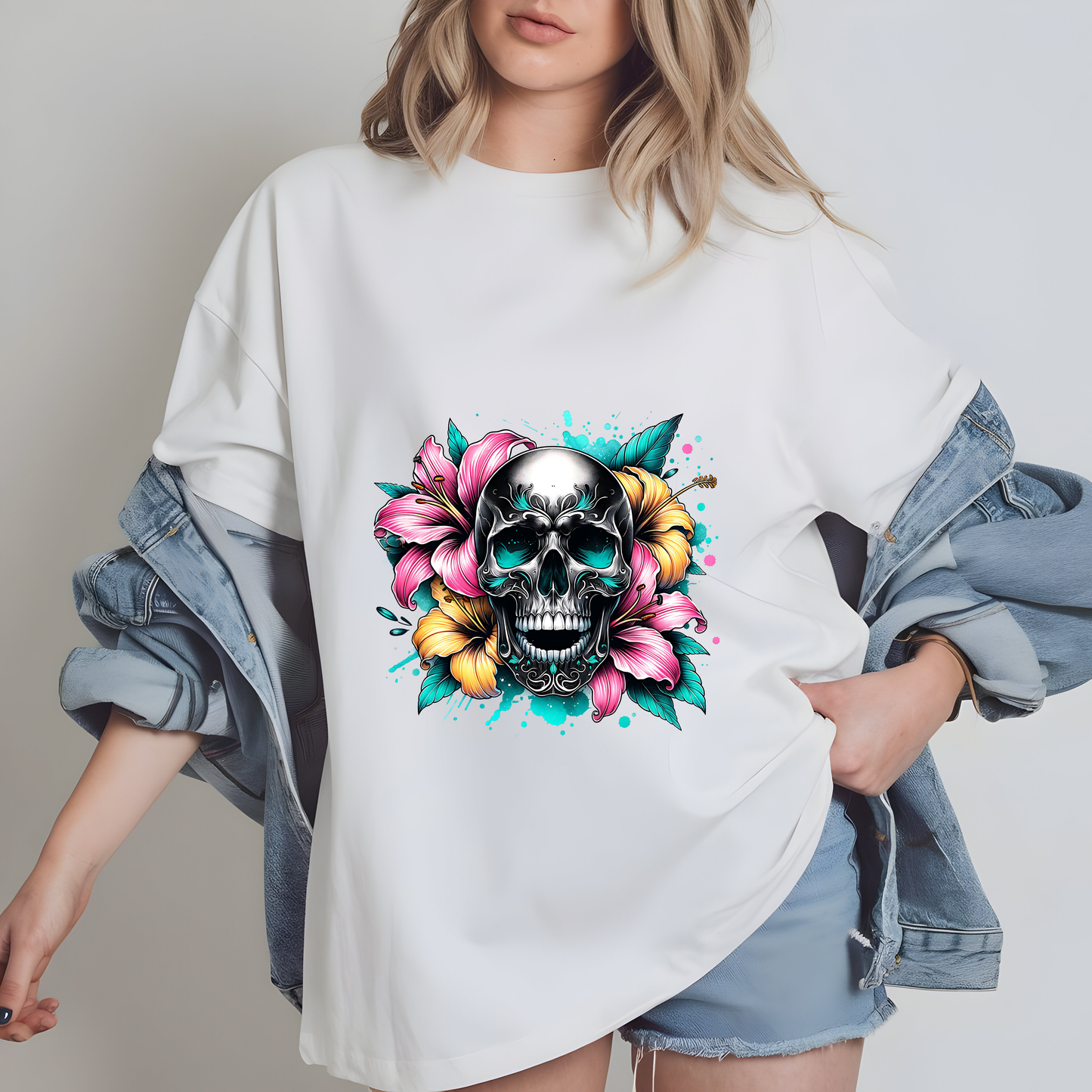 a woman wearing a white shirt with a skull and flowers on it