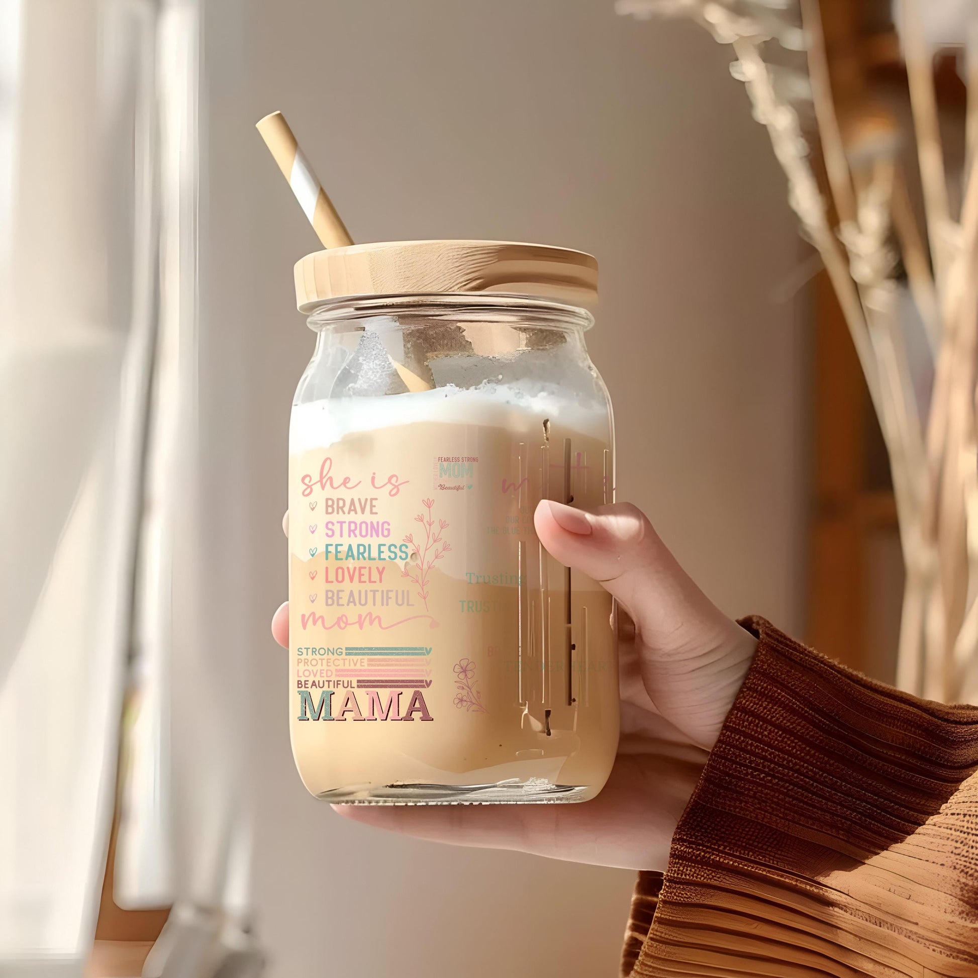 a person holding a jar with a straw in it