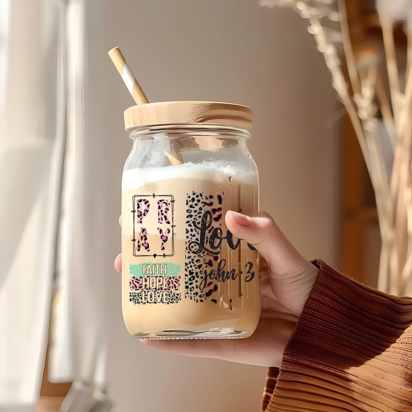a person holding a jar with a straw in it