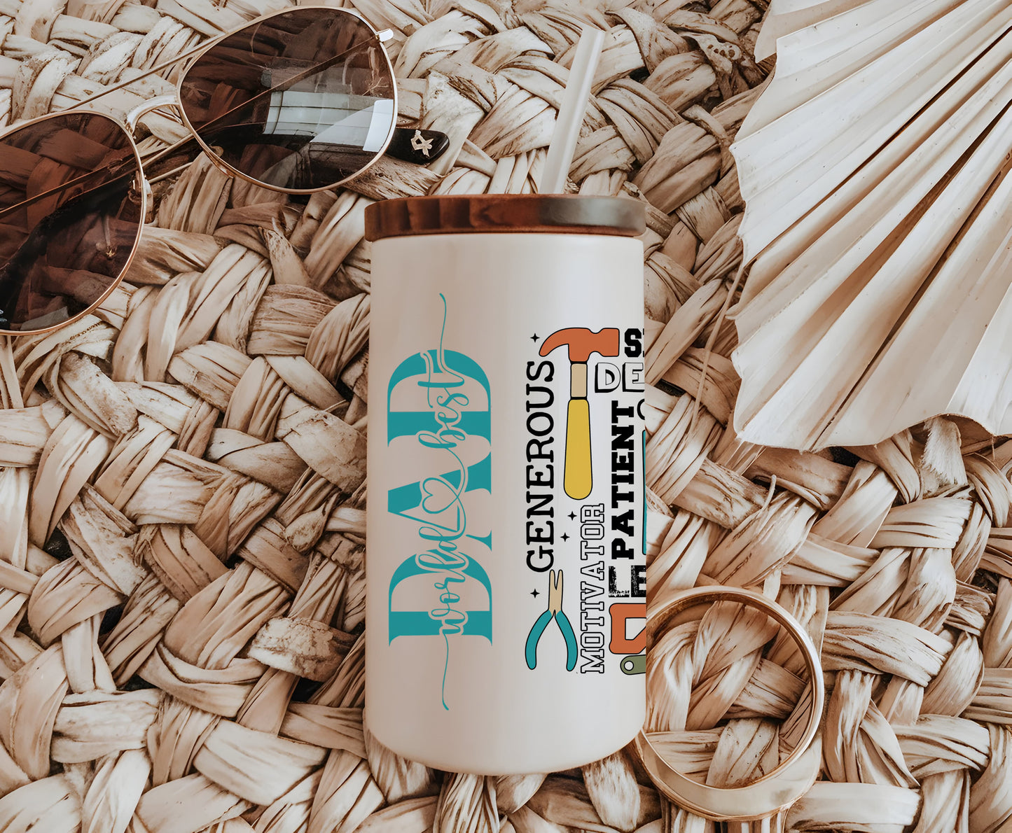 a white coffee cup sitting on top of a table next to a pair of sunglasses