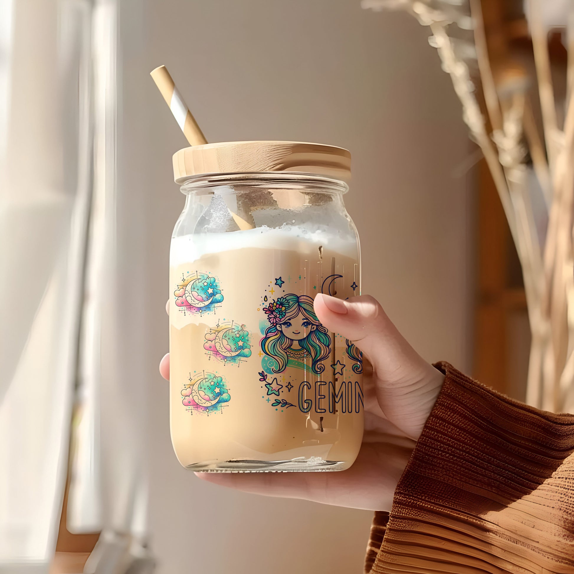 a person holding a jar with a straw in it