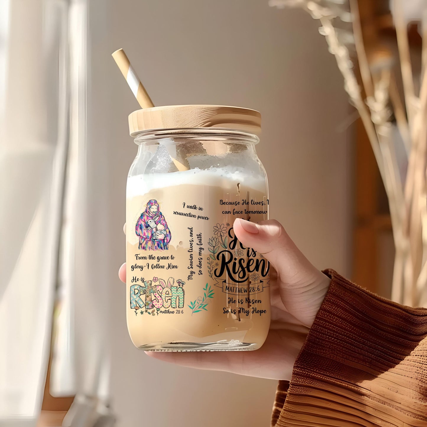 a person holding a jar with a straw in it