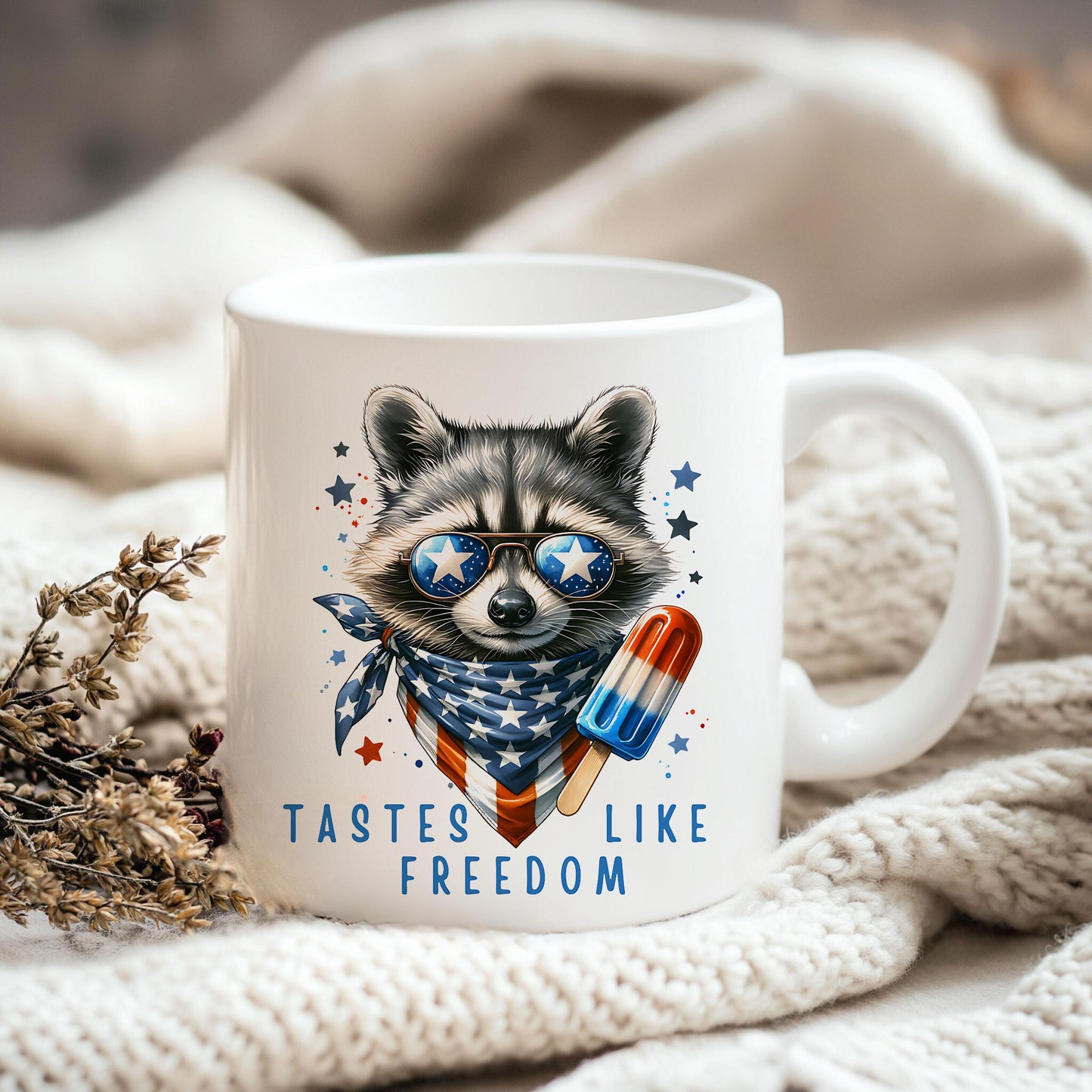 a raccoon wearing sunglasses and a scarf is sitting on a blanket