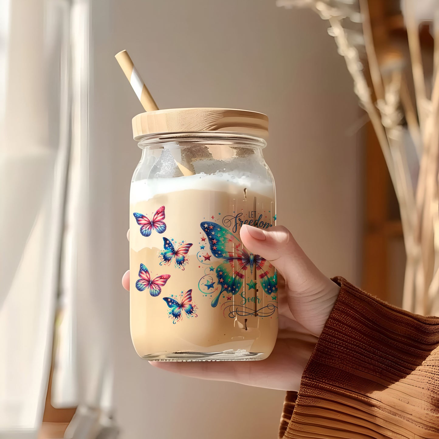 a person holding a jar with a straw in it