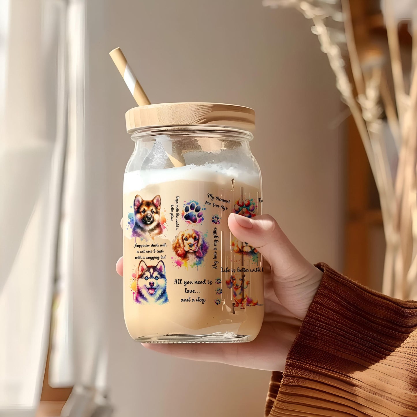 a person holding a glass jar with a straw in it