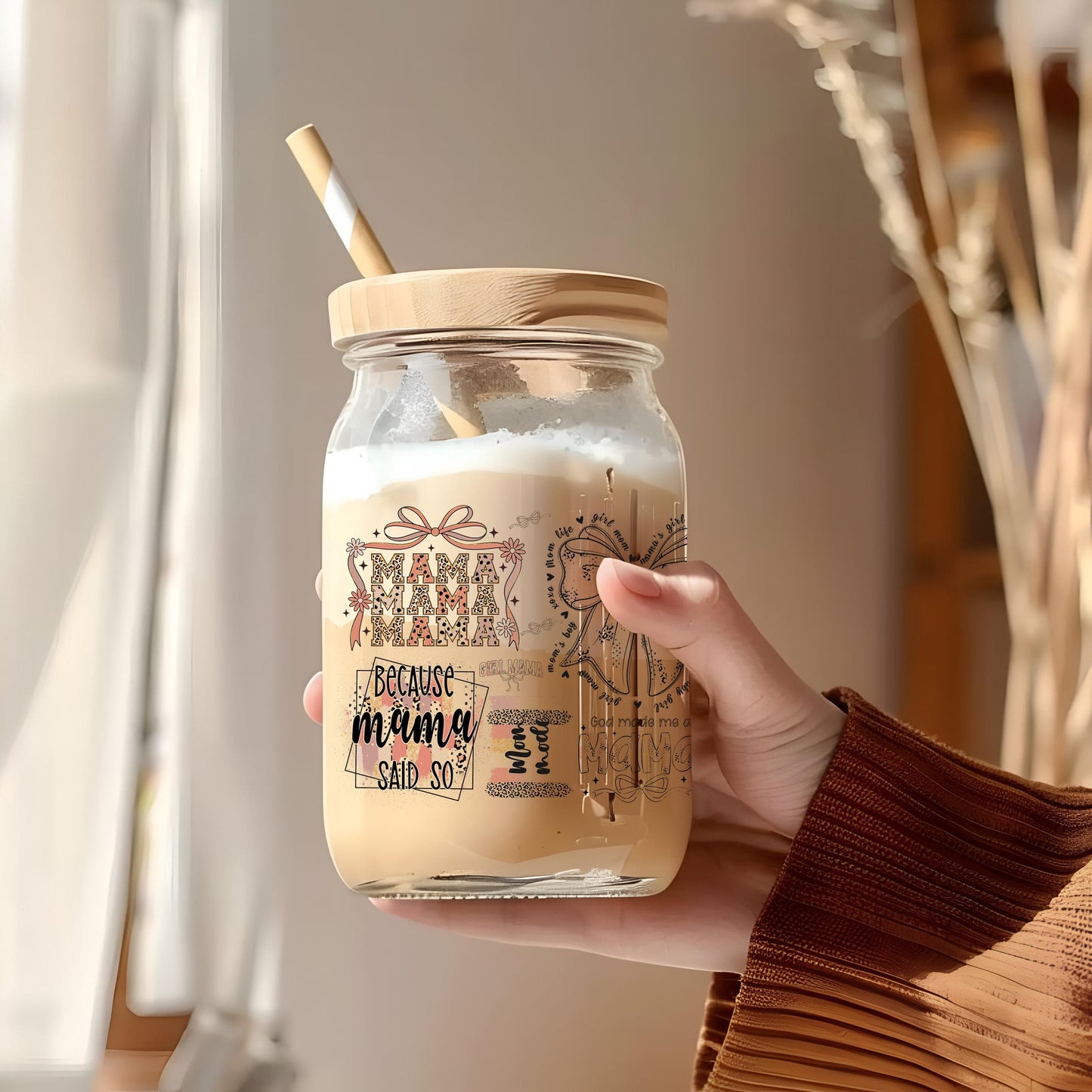 a person holding a mason jar with a straw in it