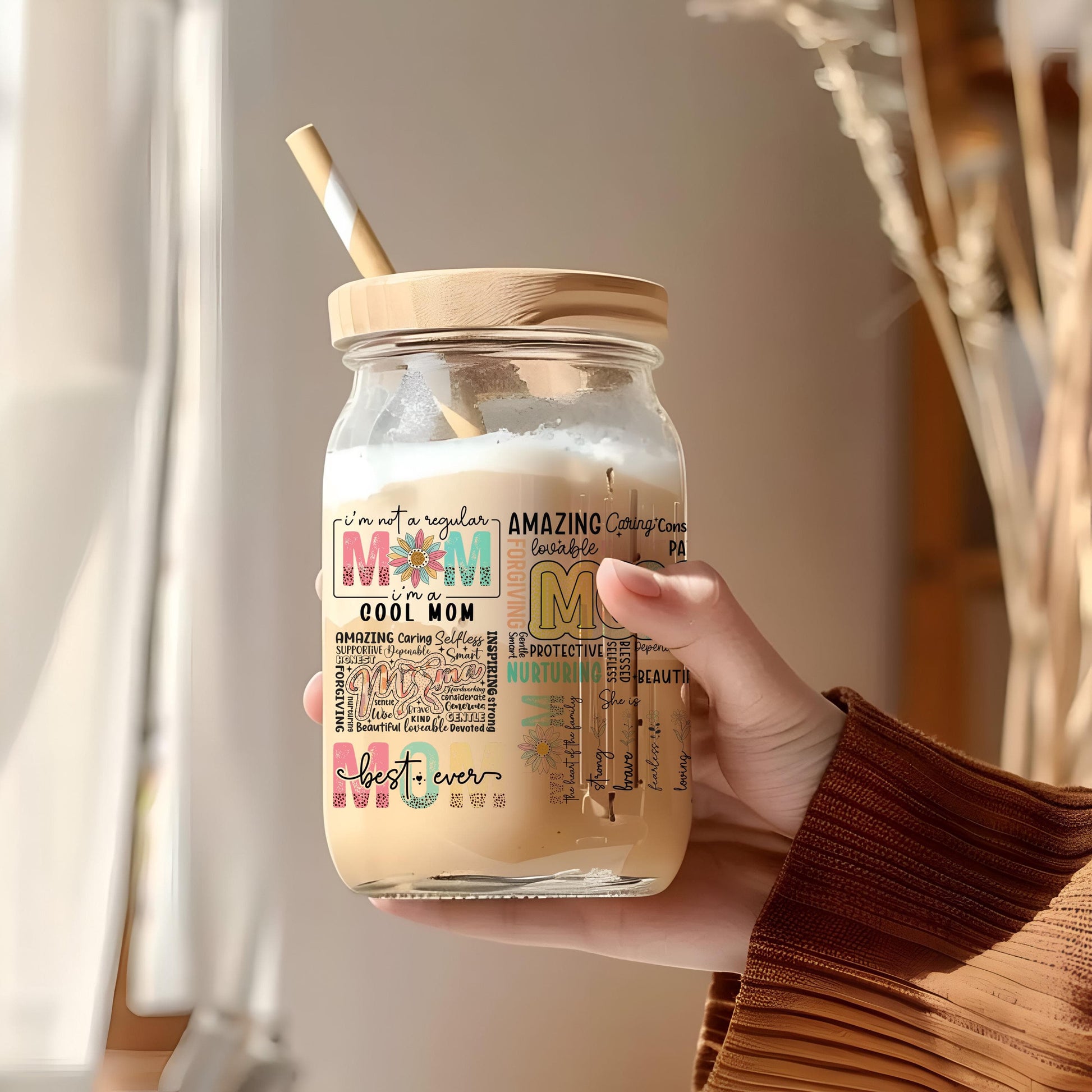 a person holding a mason jar with a straw in it