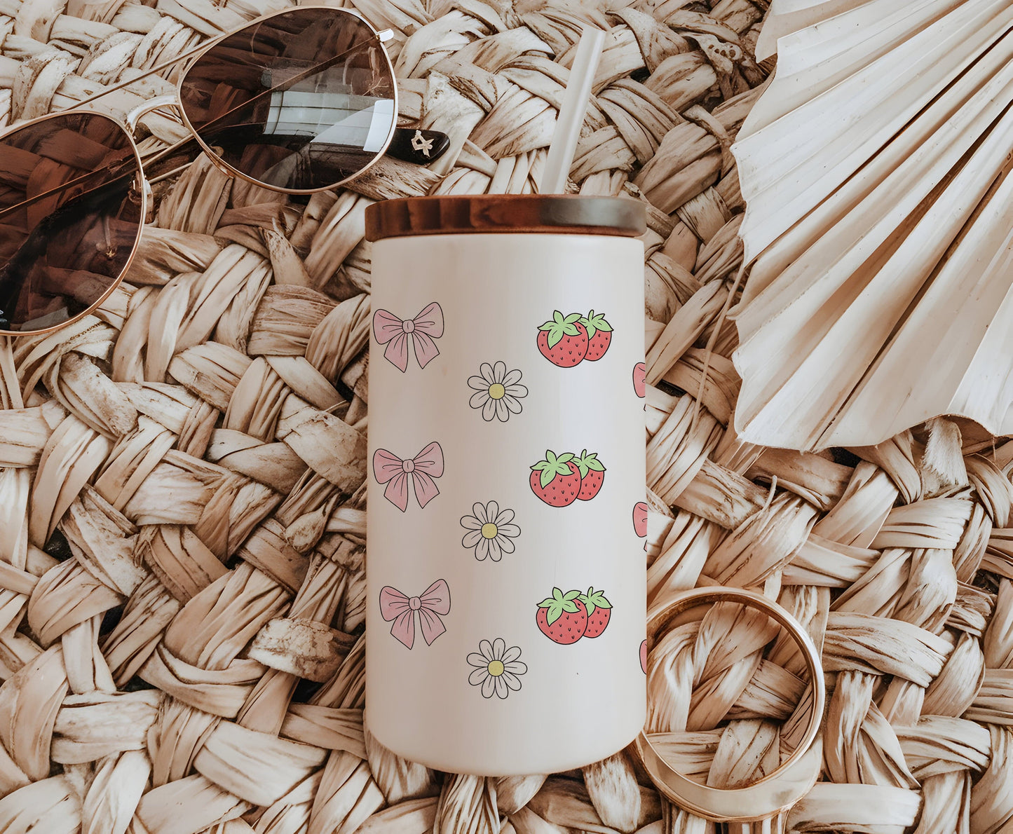 a straw hat, sunglasses, strawberries and a straw hat on a wicker