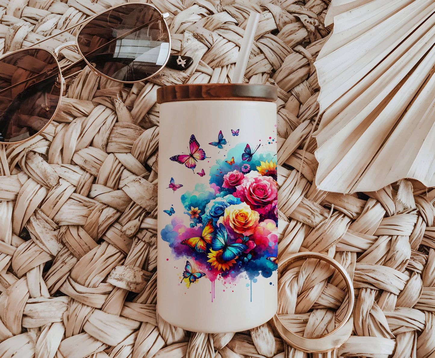 a white coffee mug with a painting of flowers and butterflies on it