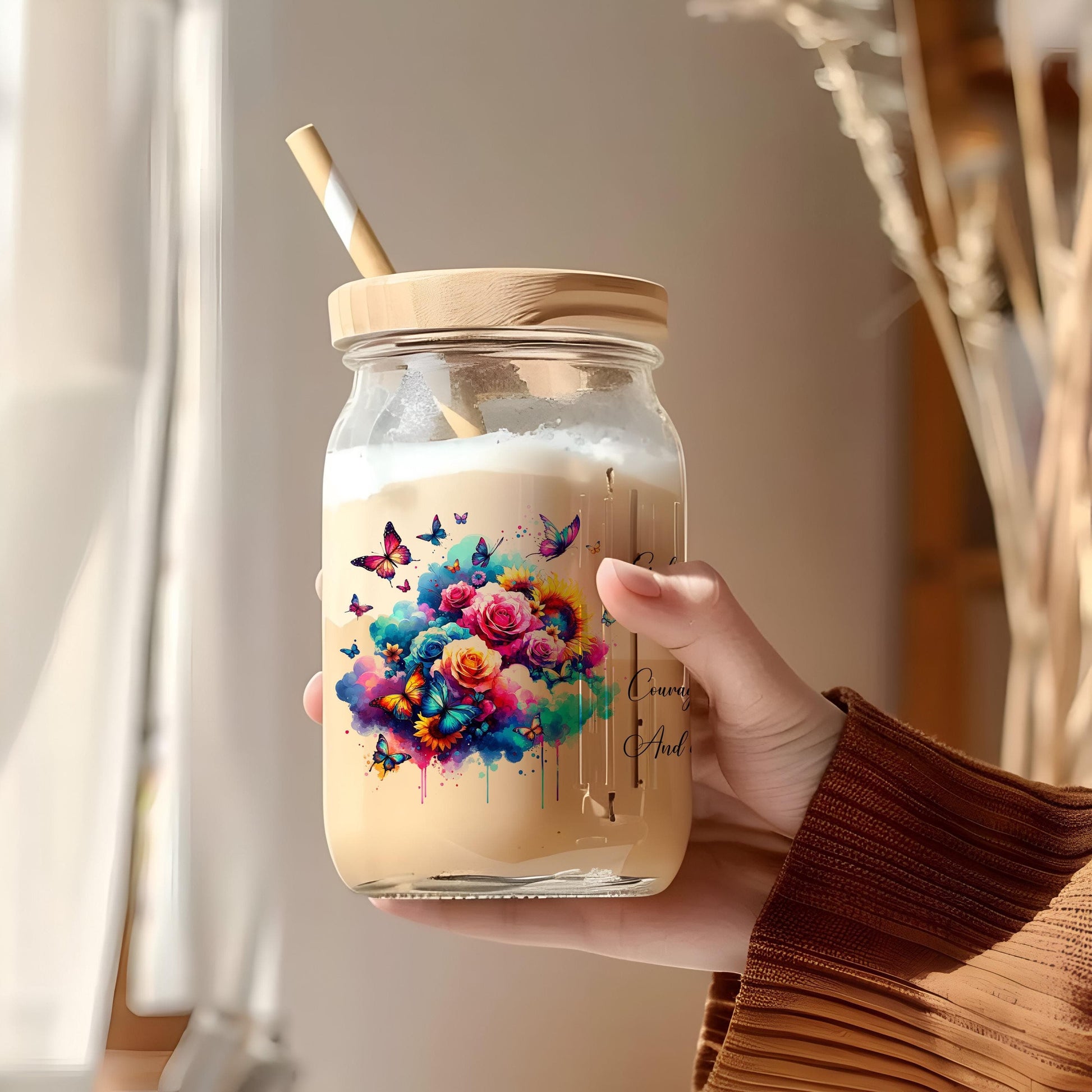 a person holding a jar with a straw in it