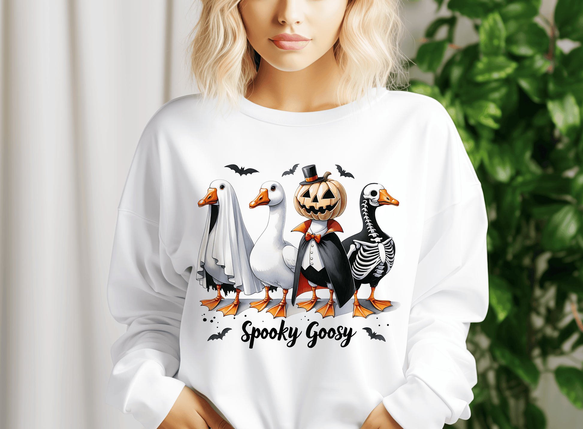 a woman wearing a white shirt with a picture of ducks and geese on it