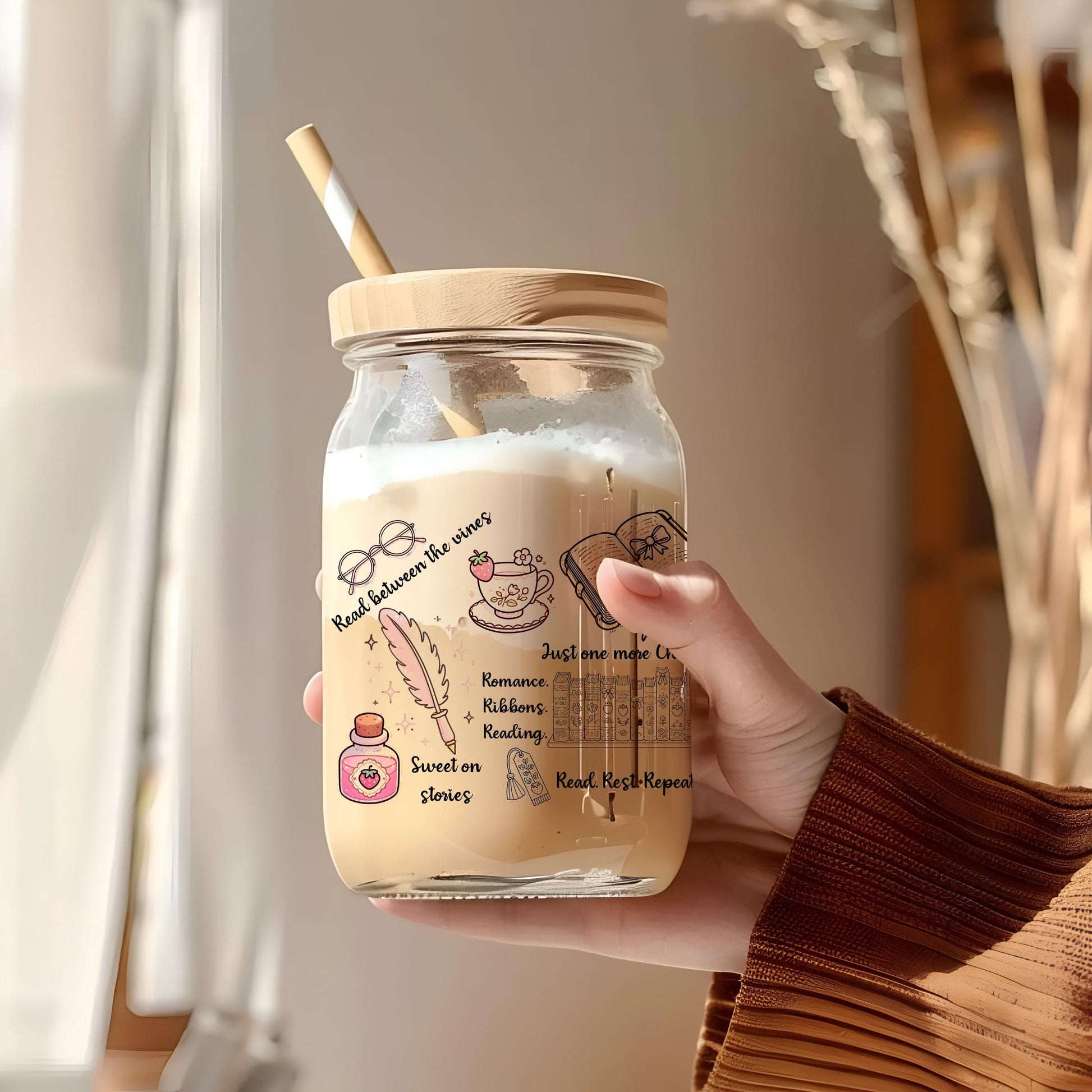a person holding a jar with a straw in it
