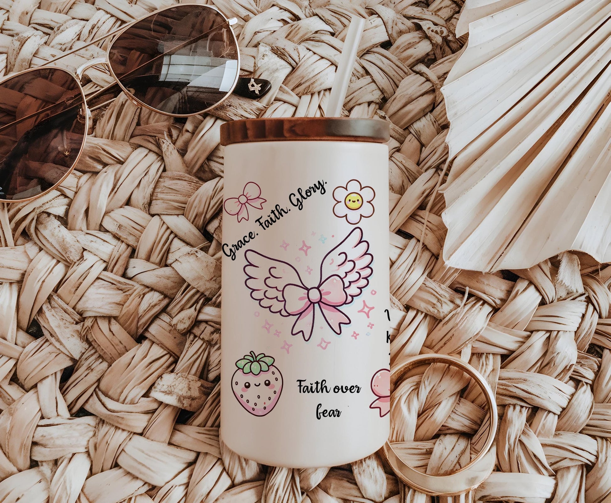 a cup with a straw hat and sunglasses on top of it